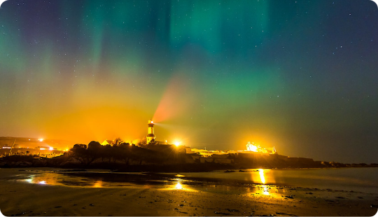 The Northern Lights overlooking a coast
