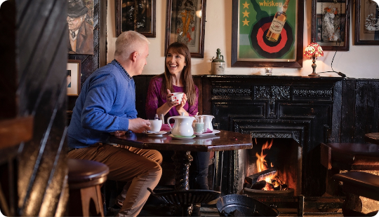 Two people enjoying time in cosy pub